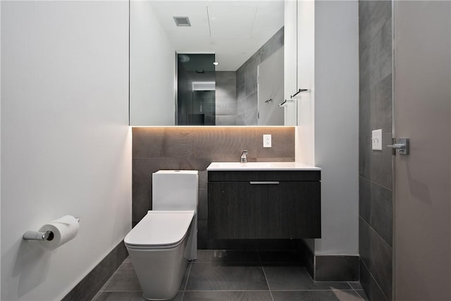 bathroom with visible vents, backsplash, toilet, tile patterned floors, and vanity