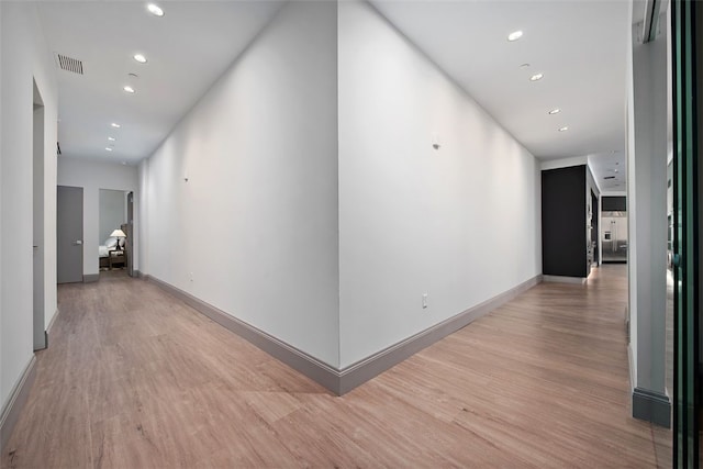 corridor featuring recessed lighting, visible vents, light wood finished floors, and baseboards