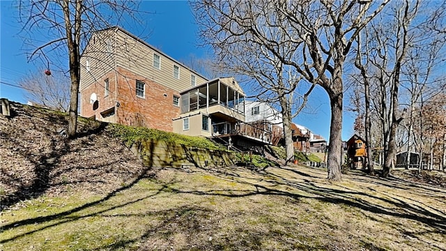 rear view of property with a sunroom