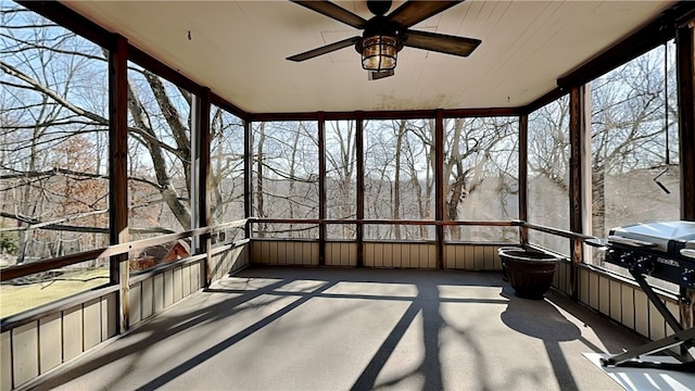 unfurnished sunroom with a ceiling fan