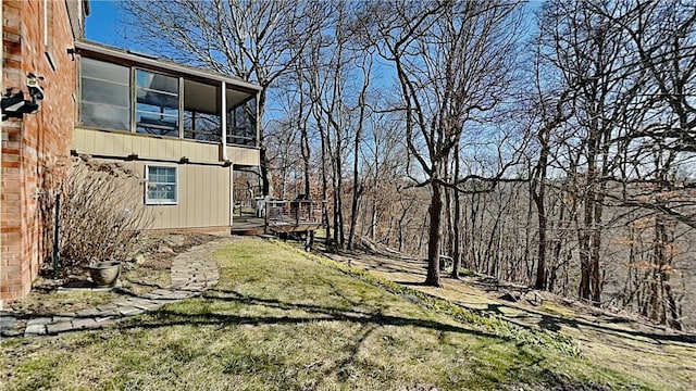 view of yard with a deck and a sunroom