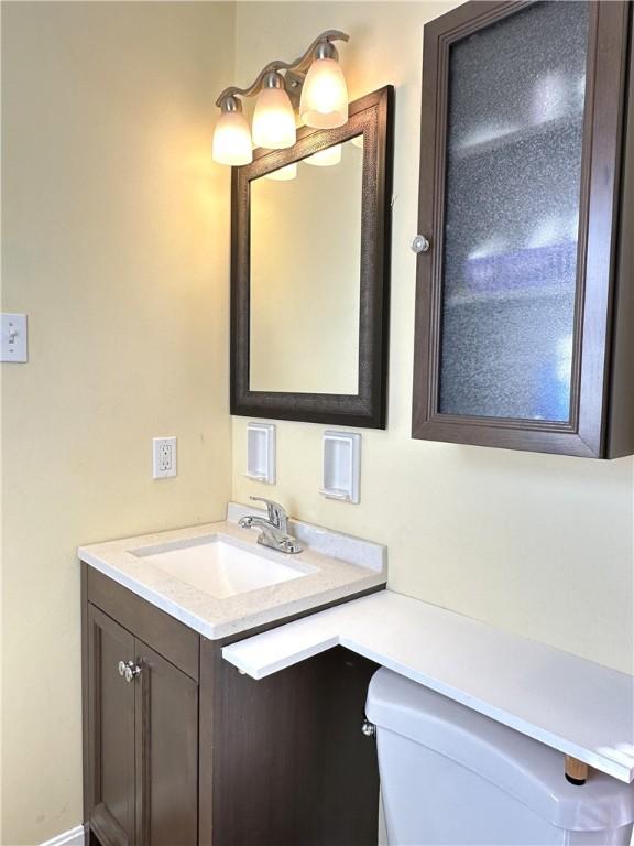 bathroom with toilet and vanity