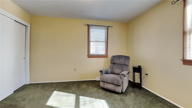 sitting room with baseboards and carpet floors