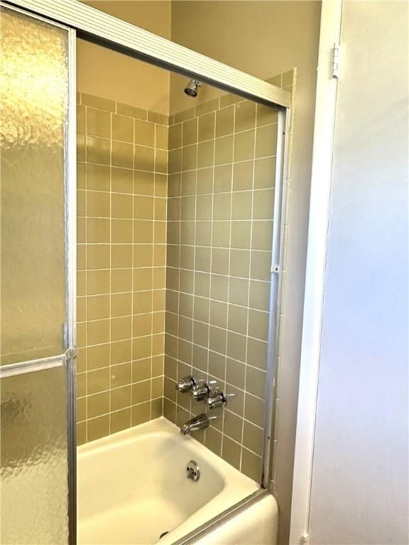 full bathroom featuring bath / shower combo with glass door