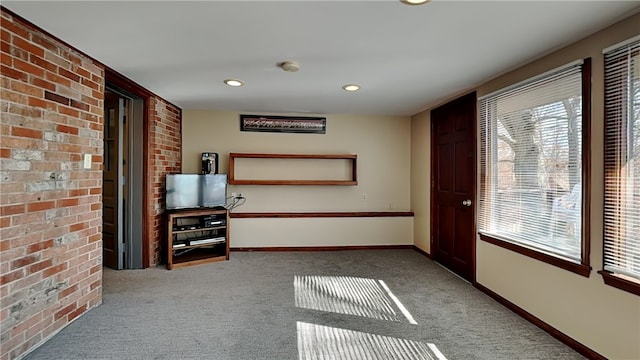 empty room featuring plenty of natural light, baseboards, and carpet floors