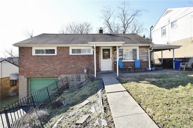 view of front facade featuring brick siding, fence, a front yard, stone siding, and an attached garage