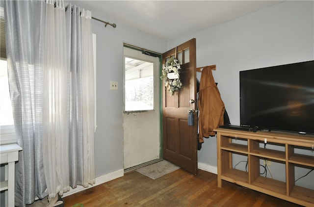 entryway with baseboards and wood finished floors