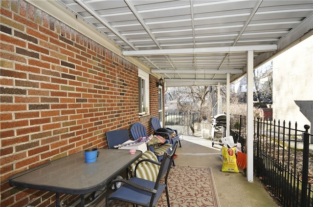 view of patio with area for grilling and fence