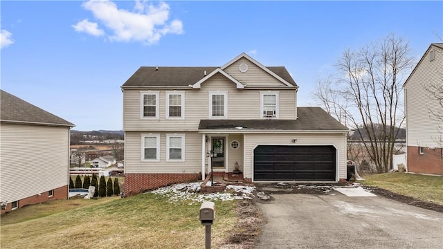 view of front facade featuring aphalt driveway, a garage, and a front lawn