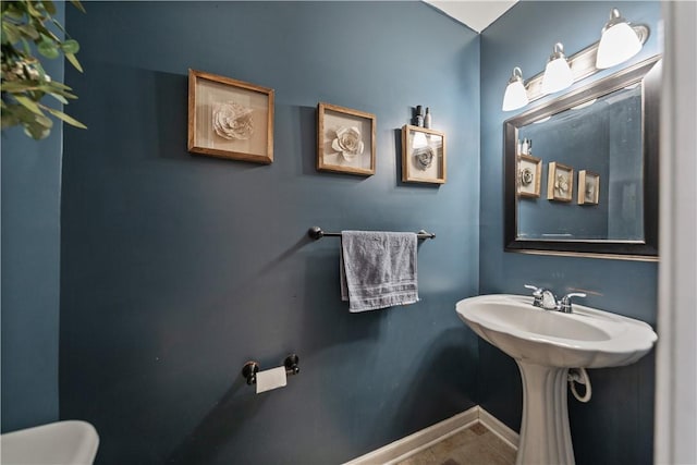 bathroom with baseboards and toilet