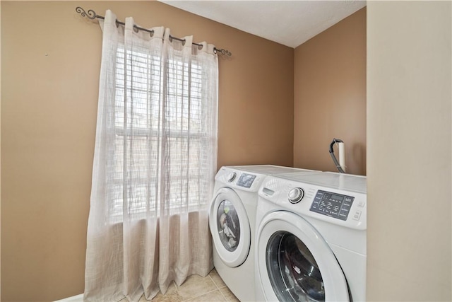 laundry area featuring washer and dryer, laundry area, and light tile patterned flooring