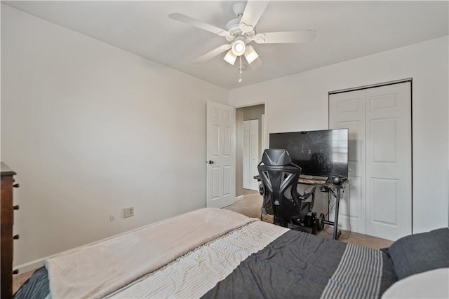 carpeted bedroom with a closet and ceiling fan