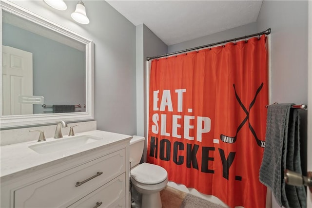 bathroom featuring a shower with shower curtain, toilet, and vanity