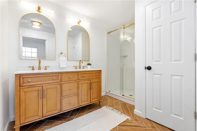 full bath with double vanity, a stall shower, and a sink