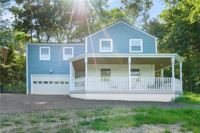 view of front facade with a garage, covered porch, and driveway