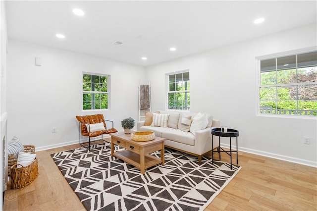 living room with recessed lighting, baseboards, plenty of natural light, and wood finished floors