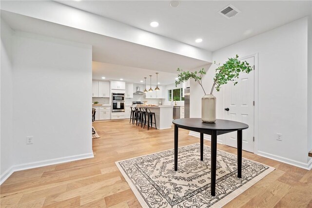 entrance foyer featuring recessed lighting, light wood-type flooring, baseboards, and visible vents