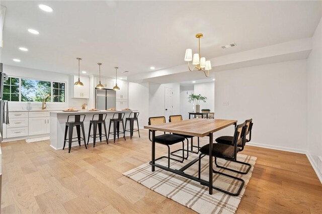 dining room with recessed lighting, light wood-type flooring, baseboards, and visible vents