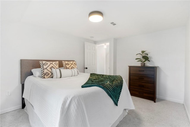 bedroom featuring light carpet, visible vents, and baseboards