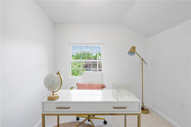 carpeted home office featuring baseboards and lofted ceiling