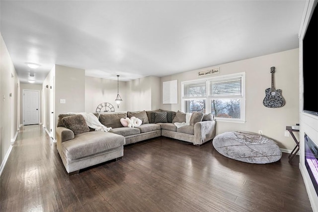 living room with dark wood finished floors and baseboards