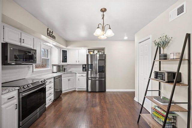 kitchen with visible vents, white cabinetry, appliances with stainless steel finishes, decorative backsplash, and dark wood-style flooring