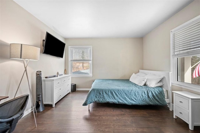 bedroom with dark wood-style floors and baseboards