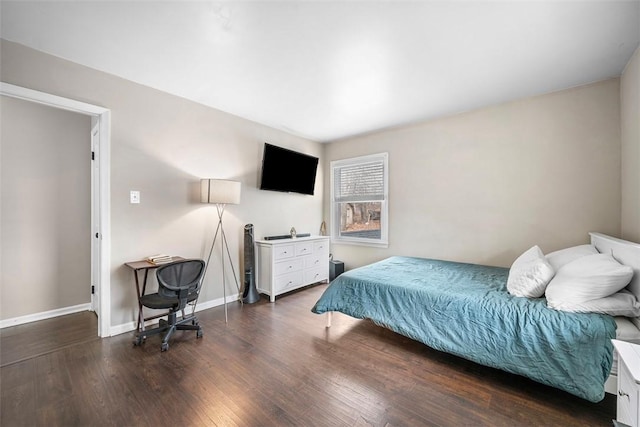 bedroom with baseboards and wood finished floors