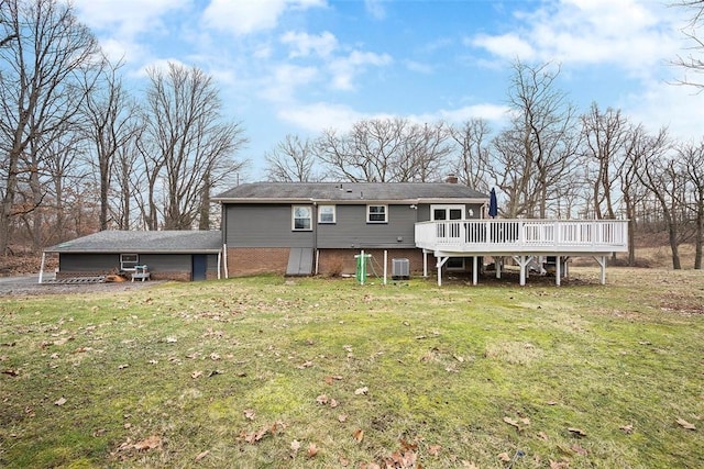 back of house featuring central air condition unit, a lawn, a chimney, and a deck