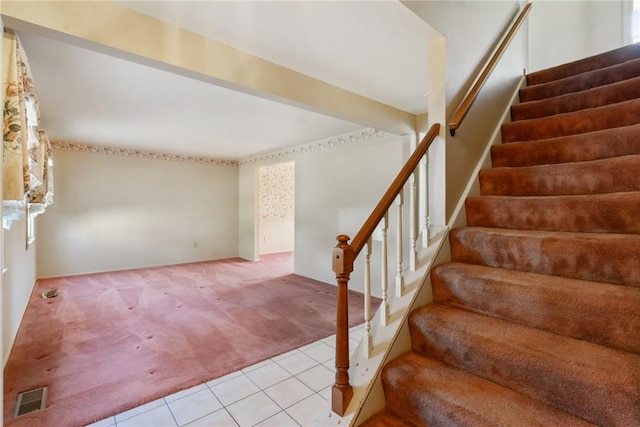 staircase with tile patterned floors, carpet, and visible vents