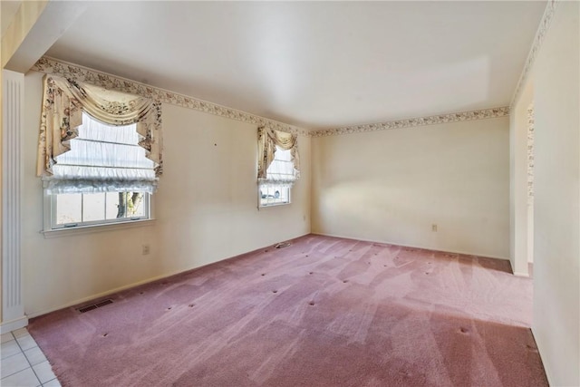 spare room with tile patterned floors, visible vents, and carpet floors