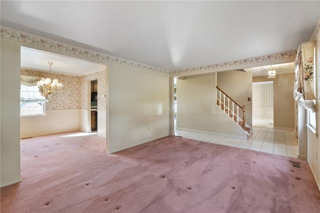 interior space with wallpapered walls, stairway, wainscoting, carpet flooring, and a chandelier