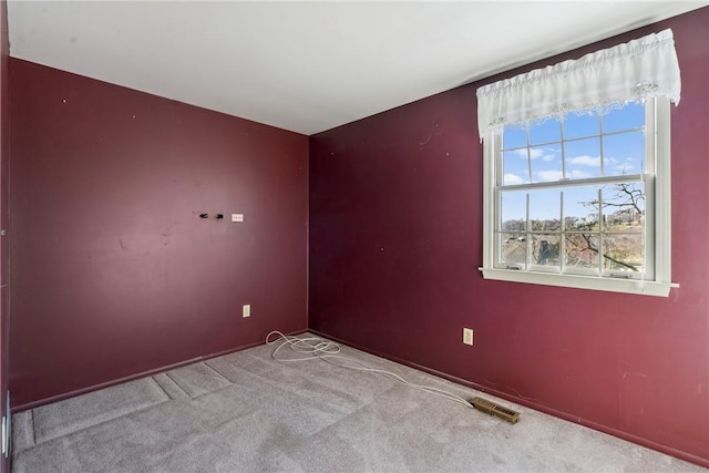 unfurnished room with visible vents and carpet flooring