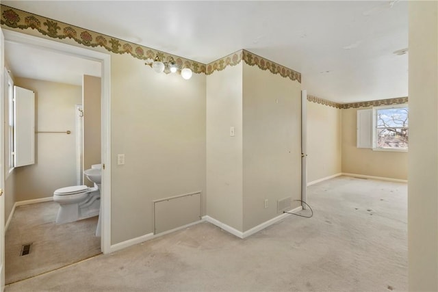 bathroom featuring visible vents, toilet, and baseboards