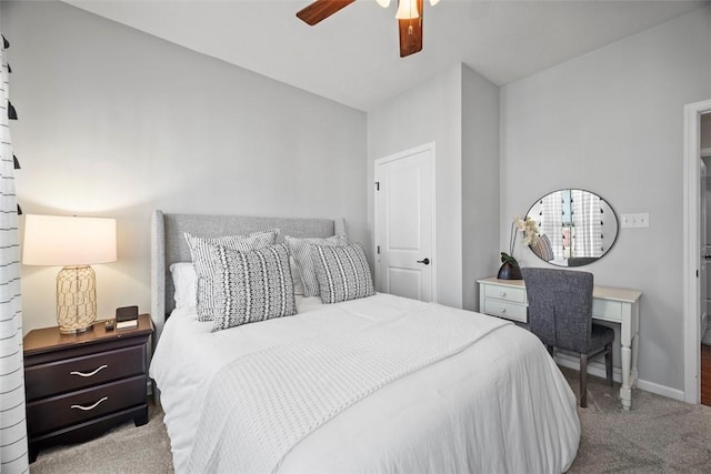 carpeted bedroom with lofted ceiling, a ceiling fan, and baseboards