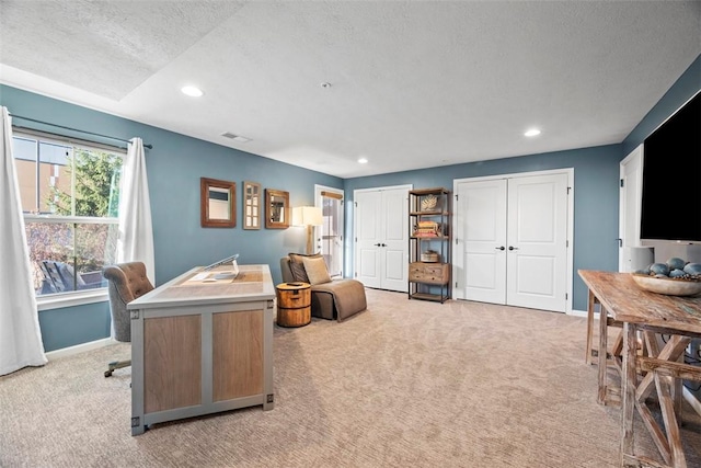 office space featuring recessed lighting, baseboards, and light carpet