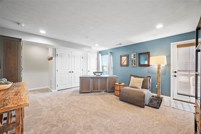 living area featuring recessed lighting, light colored carpet, and baseboards