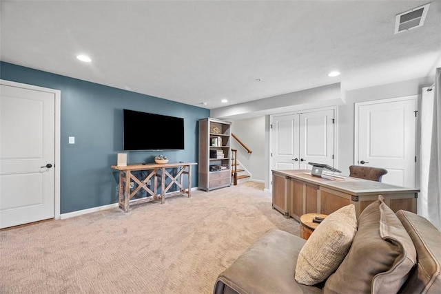 living room with light carpet, visible vents, stairs, and baseboards