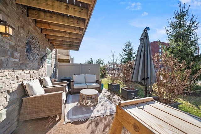 view of patio / terrace featuring an outdoor hangout area and fence