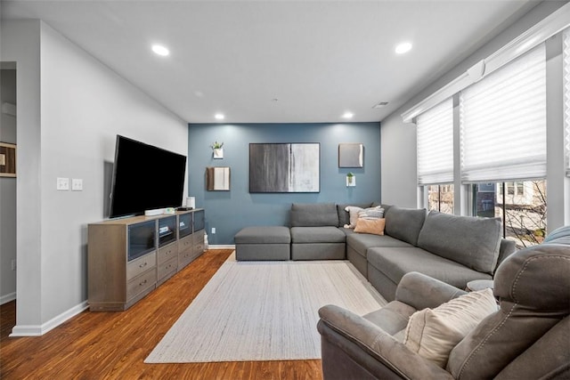 living room with visible vents, recessed lighting, baseboards, and wood finished floors