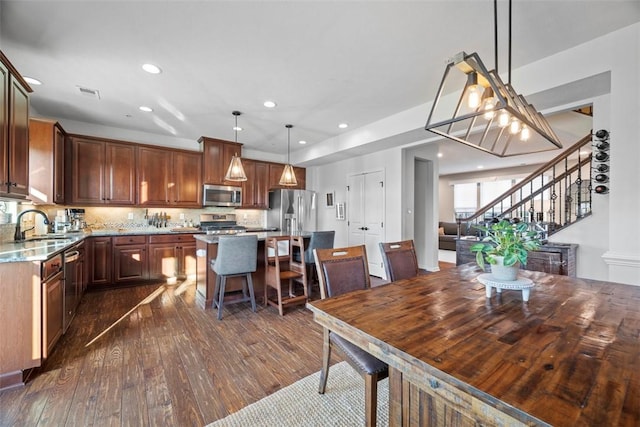 dining room with dark wood-type flooring, stairway, recessed lighting, and visible vents