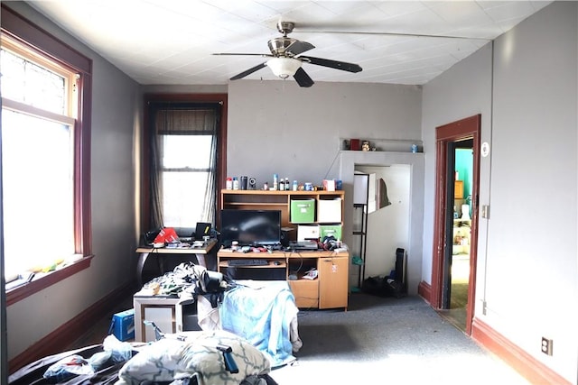 office area with a wealth of natural light, baseboards, and ceiling fan