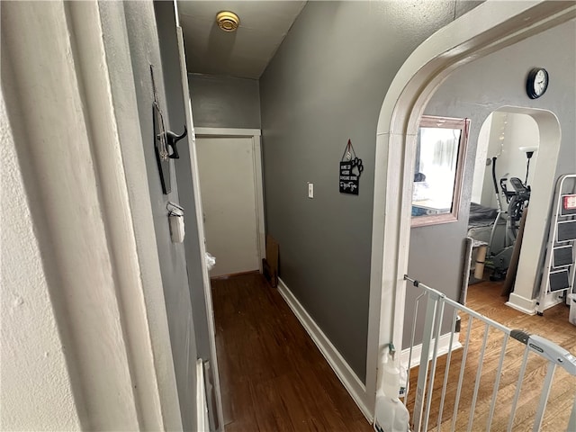 hall featuring wood finished floors and baseboards