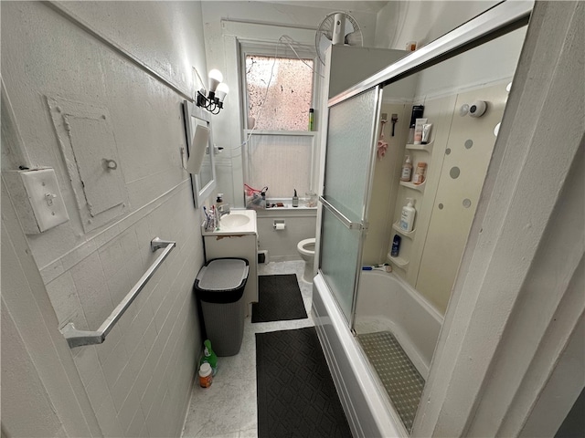 full bathroom with vanity, toilet, and bath / shower combo with glass door