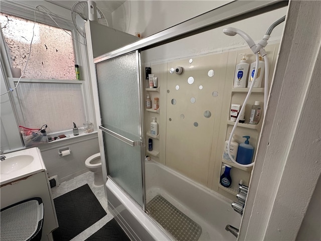 bathroom with a shower with shower door, toilet, and vanity