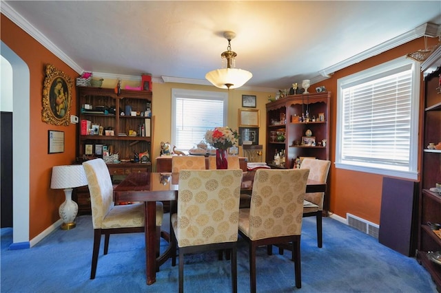 dining space with arched walkways, visible vents, carpet, and ornamental molding