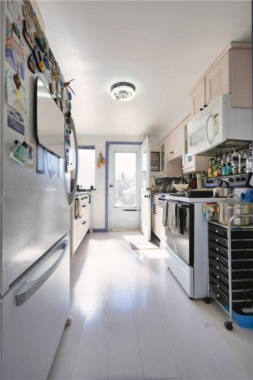 kitchen featuring light wood-style flooring and white appliances