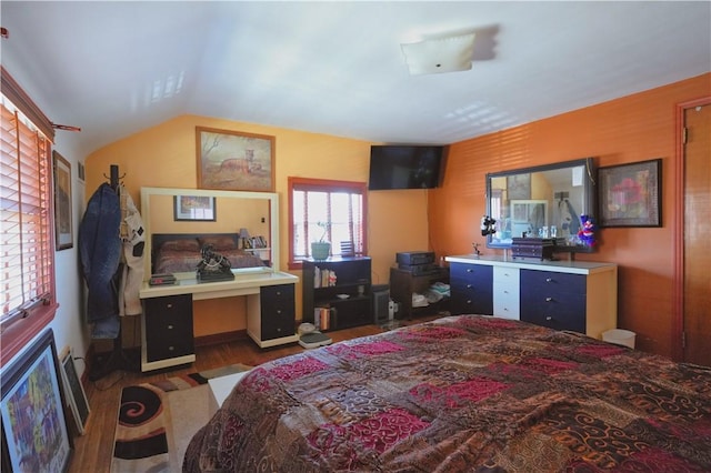 bedroom featuring vaulted ceiling and wood finished floors