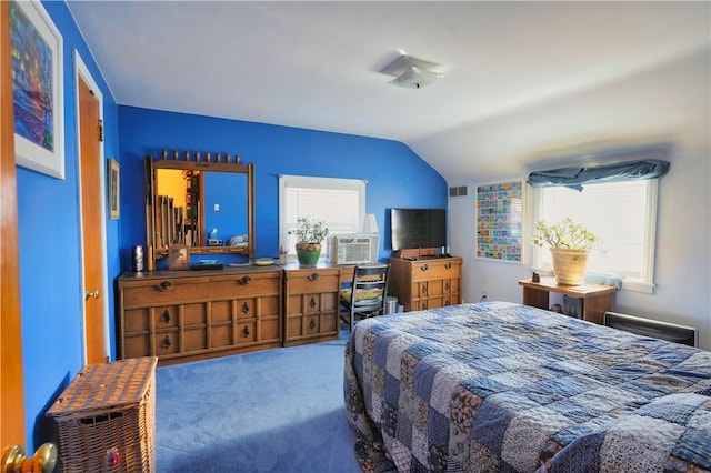 bedroom featuring multiple windows, carpet floors, and lofted ceiling