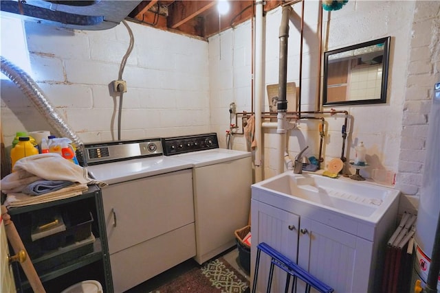 laundry area featuring washing machine and clothes dryer, laundry area, and a sink